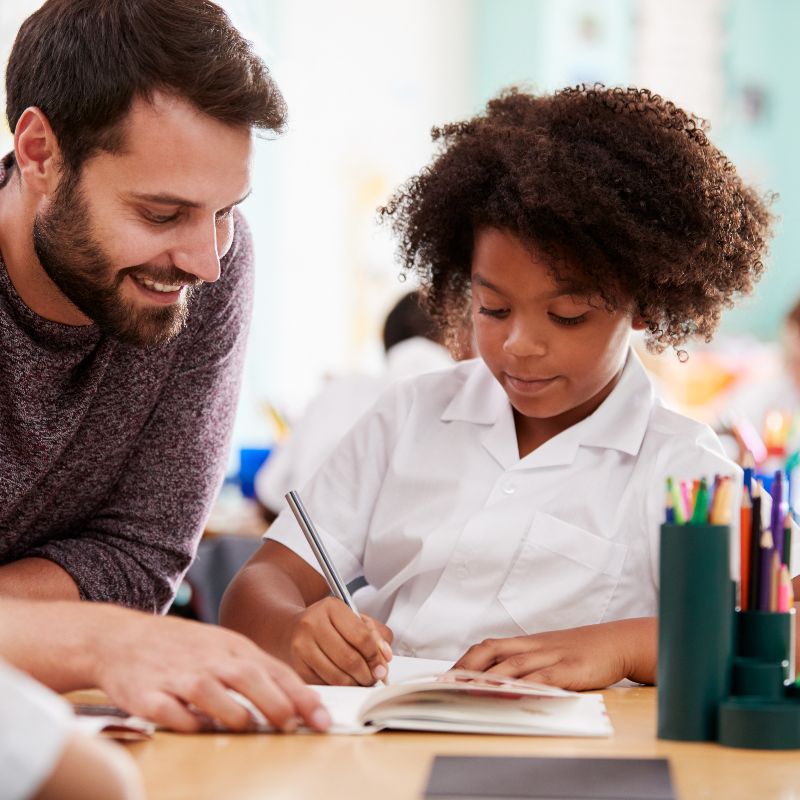 teacher and student at a desk